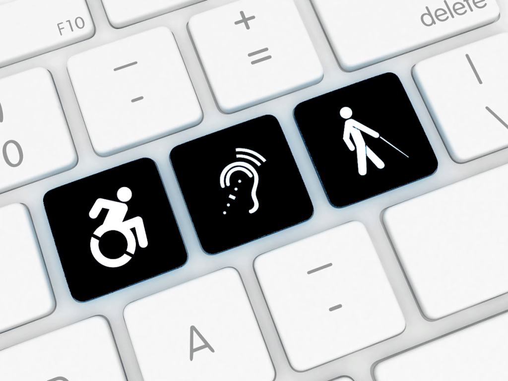 Mynd af lyklaborði þar sem eru þrír hnappar með táknum aðgengis: þ.e. fólk sem er 1) hreyfihamlað 2) með heyrnaskerðingu 3) fólks sem er blint eða með sjónskerðingu